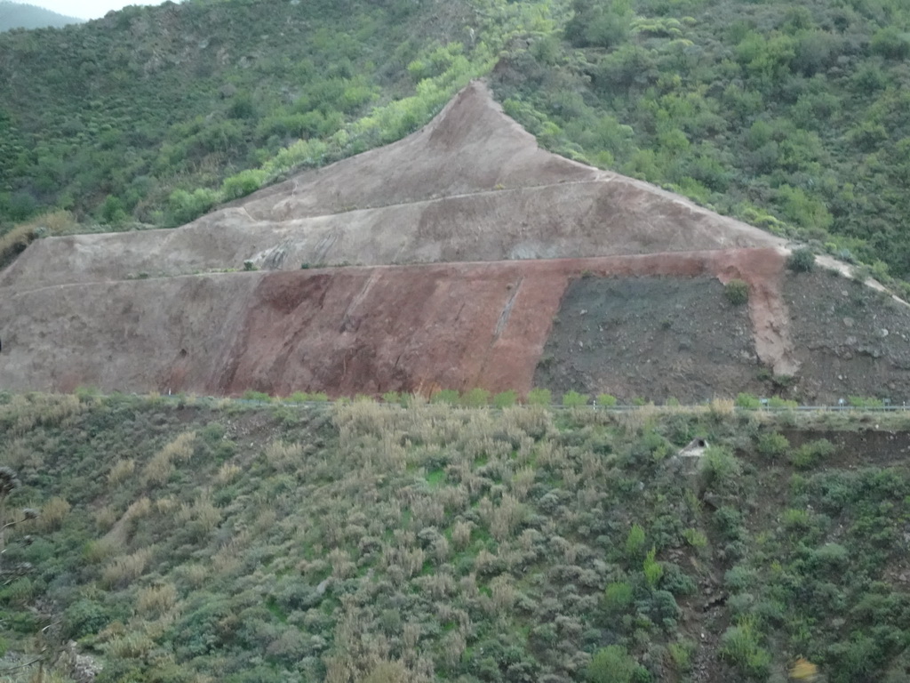 Rock wall at the Galindo street, viewed from the tour bus on the GC-60 road