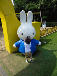 Max with a Nijntje statue in front of the playground at the Madurodam miniature park