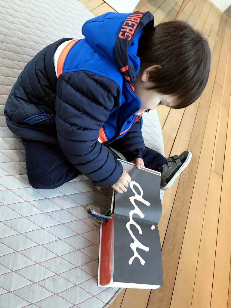 Max with a book about Dick Bruna at the upper floor of the Museum Shop of the Centraal Museum