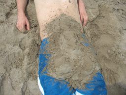 Tim buried under the sand at the beach at the east side of Valencia