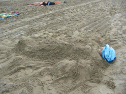 Tim buried under the sand at the beach at the east side of Valencia