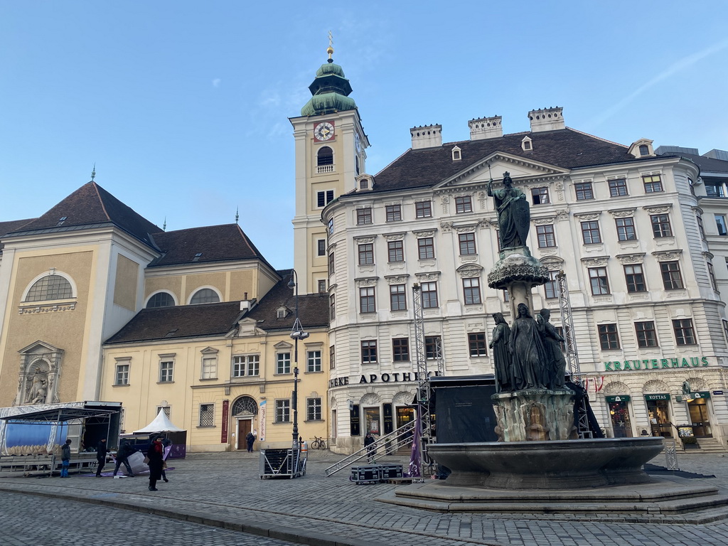 Austriabrunnen fountain and the front of the Benediktushaus im Schottenstift hotel at the Freyung square