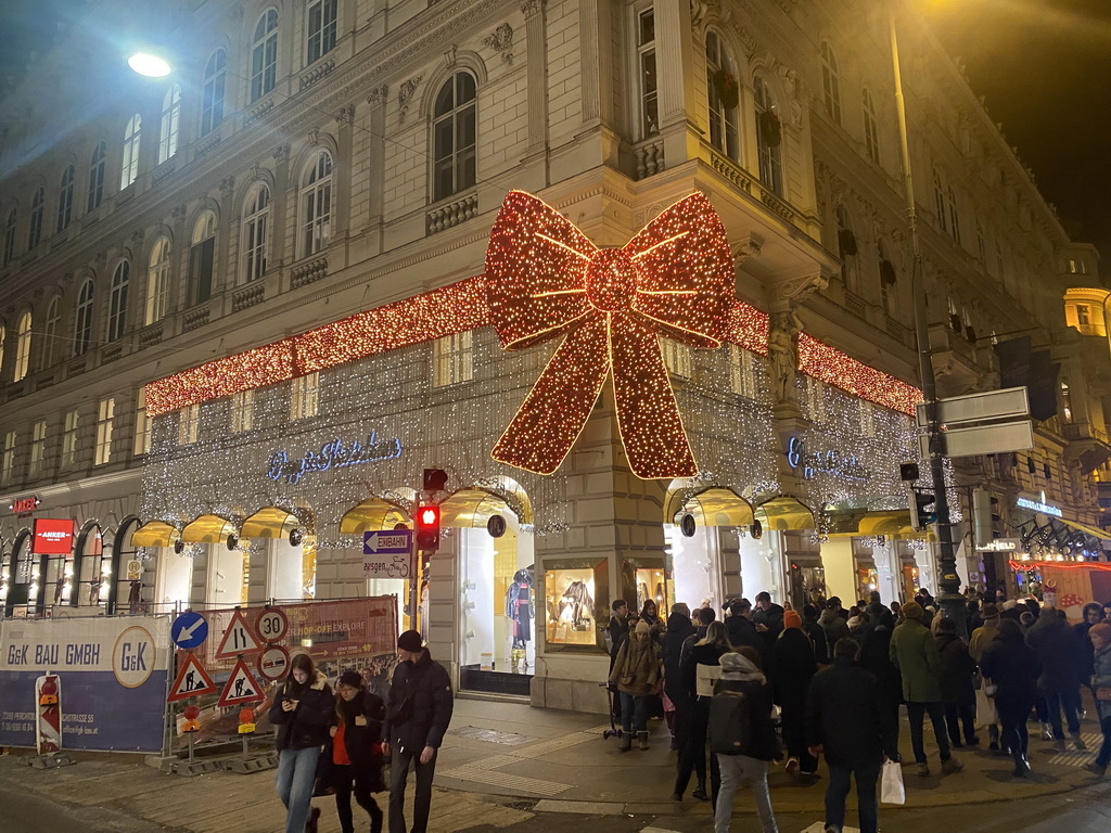 Decorative lights on a store at the crossing of the Walfischgasse and Kärntner Straße streets, by night