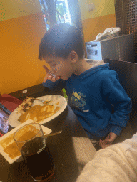 Max eating curry at the Spice of India restaurant