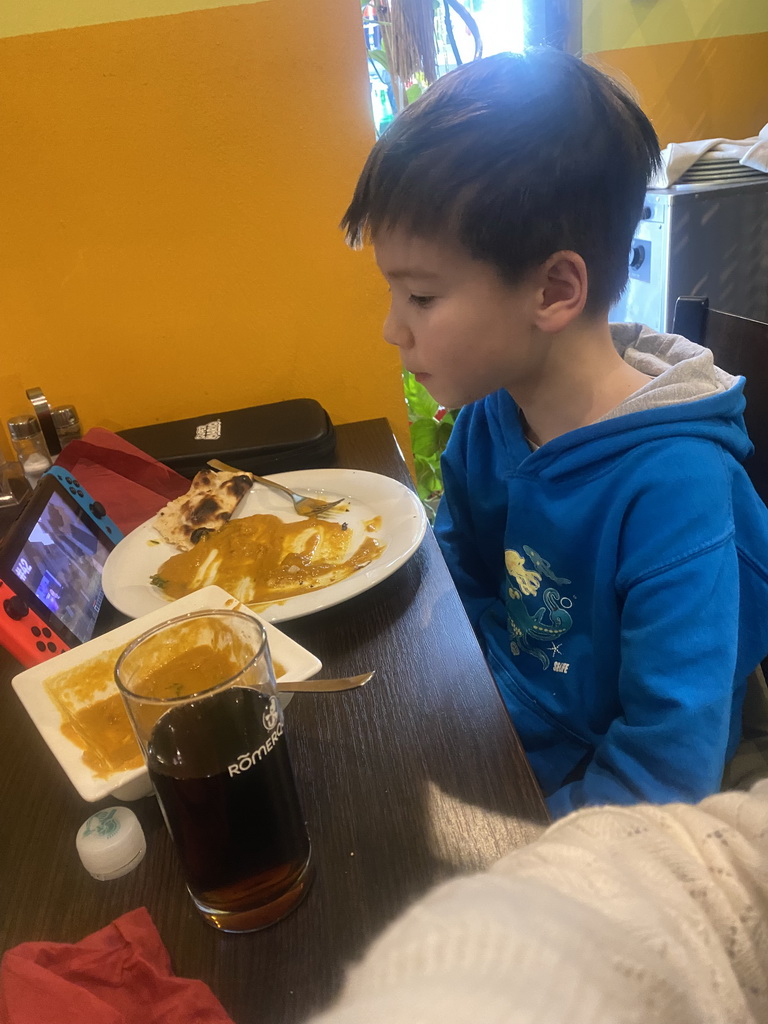 Max eating curry at the Spice of India restaurant