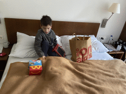 Max eating McDonald`s in our room at the fourth floor of the Benediktushaus im Schottenstift hotel