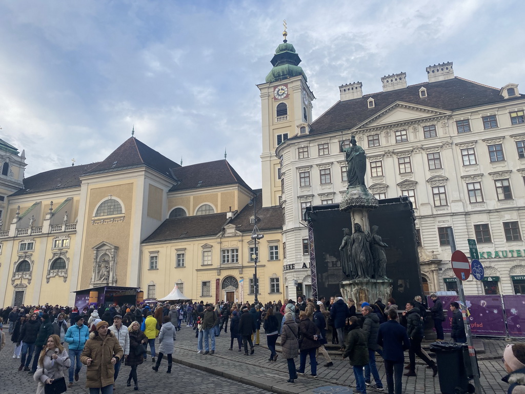 Austriabrunnen fountain and the front of the Benediktushaus im Schottenstift hotel at the Freyung square