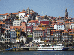 Boat on the Douro river and Porto with the Cais da Estiva street, the Capela de Nossa Senhora do Ó chapel, the Mercado Ferreira Borges market, the Igreja de Nossa Senhora da Vitória church and the Torre dos Clérigos tower, viewed from the Avenida de Diogo Leite street