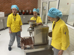 People making chocolate at the Chocolate Factory section at the Chocolate Story museum at the WOW Cultural District