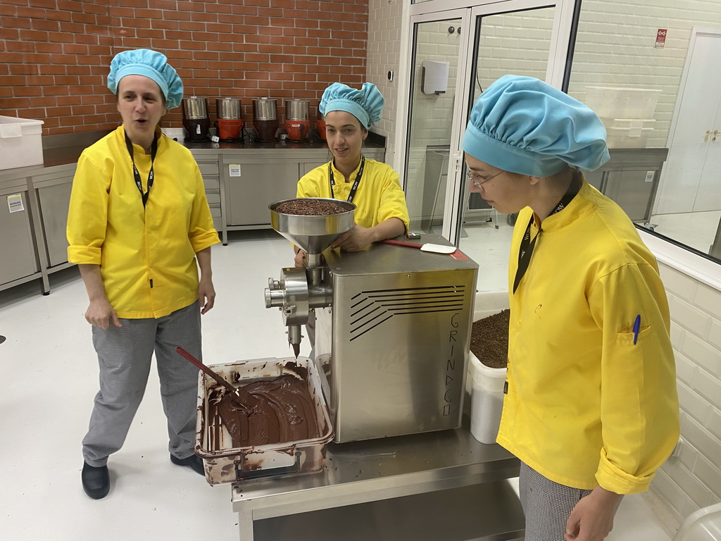 People making chocolate at the Chocolate Factory section at the Chocolate Story museum at the WOW Cultural District