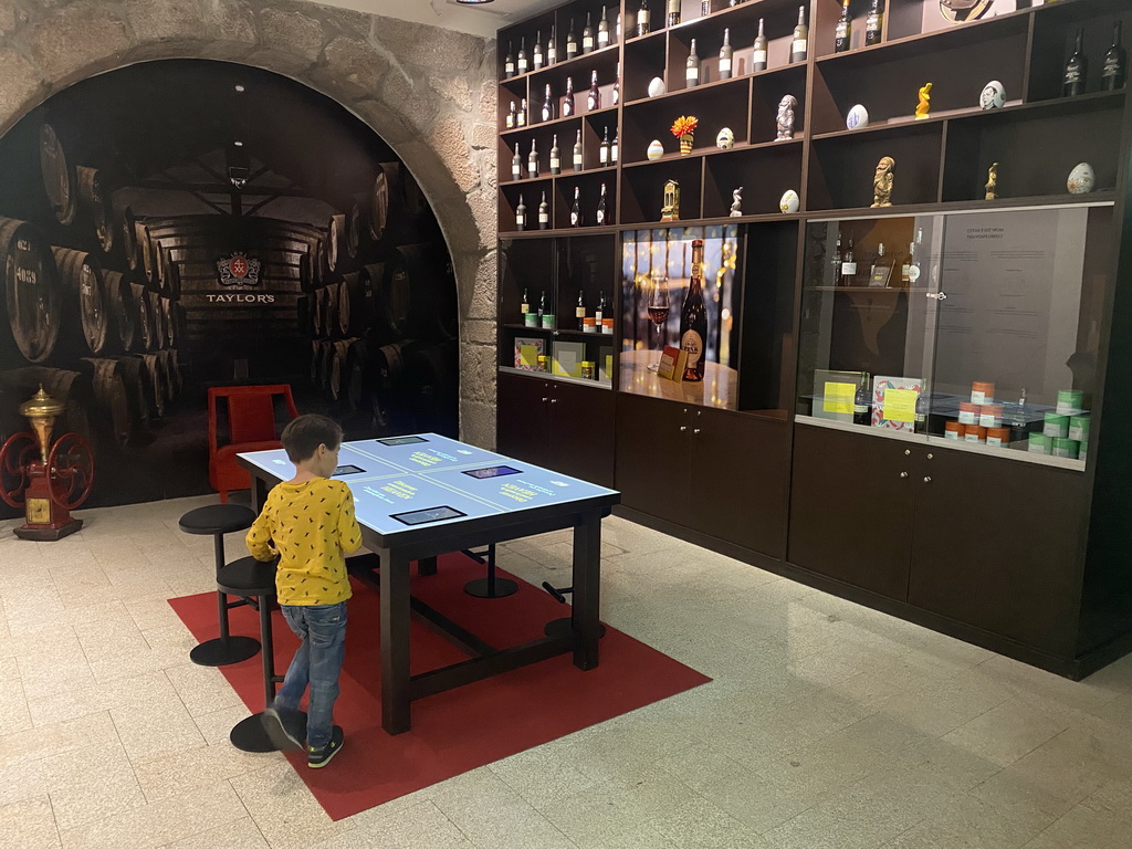 Max with wine bottles and statuettes at the Chocolate Story museum at the WOW Cultural District