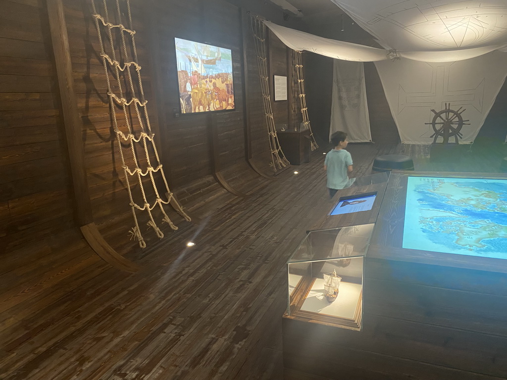 Max in a room like the interior of a Portuguese ship at the Porto Region Across the Ages museum at the WOW Cultural District