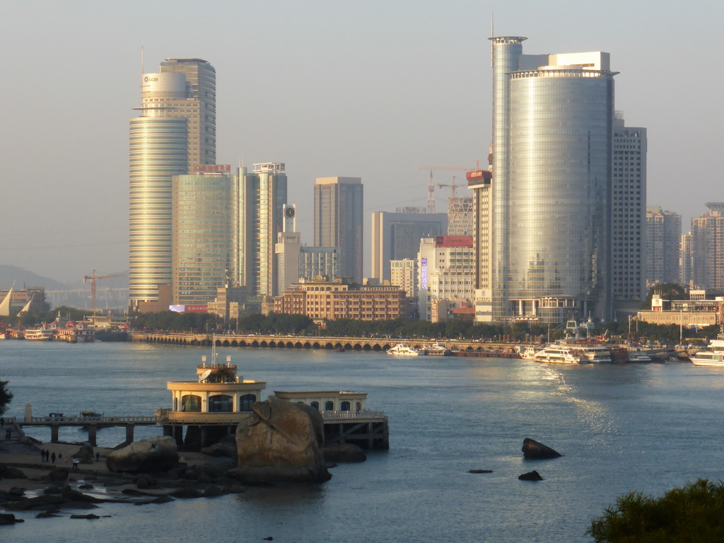 Skyscrapers at the west side of Xiamen Island, Xiamen Bay and a pier with pavilion, viewed from Fuding Rock at the Haoyue Park at Gulangyu Island