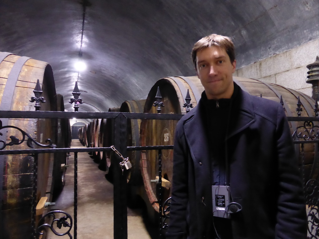 Tim with large wine barrels in the Underground Cellar at the ChangYu Wine Culture Museum