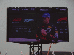 TV screen with Max Verstappen being interviewed at the pit straight at Circuit Zandvoort, viewed from the Eastside Grandstand 3, right after the Formula 1 Race