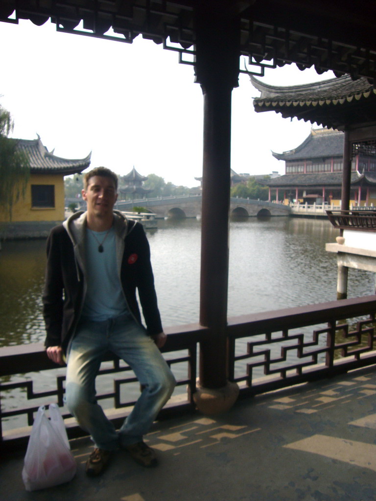 Tim in front of a bridge and pavilions of the Chengxu Temple at the Zhouzhuang Water Town